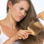 Frustrated woman looking on hair ends