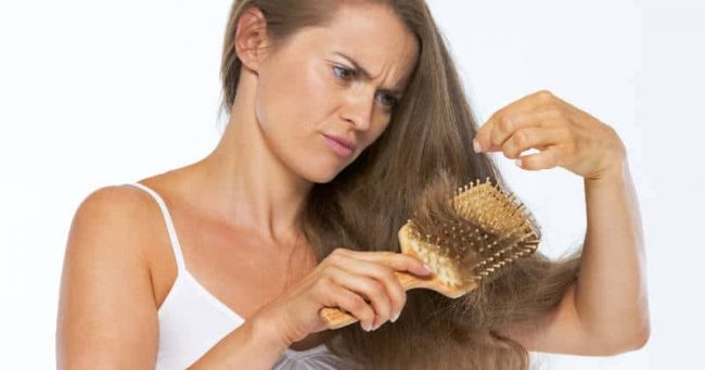 Frustrated woman looking on hair ends