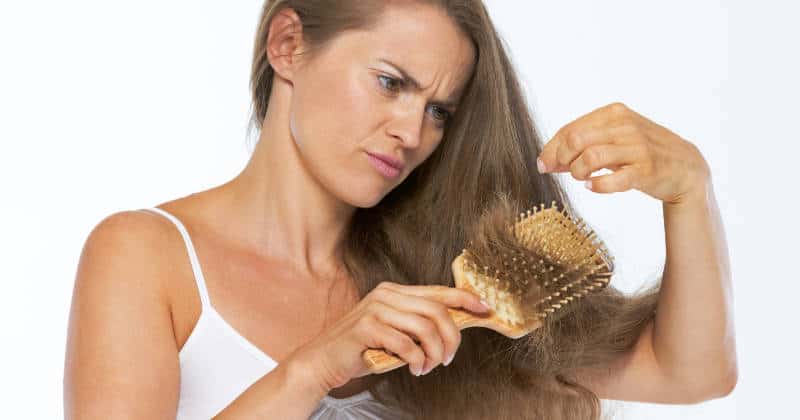 Frustrated woman looking on hair ends