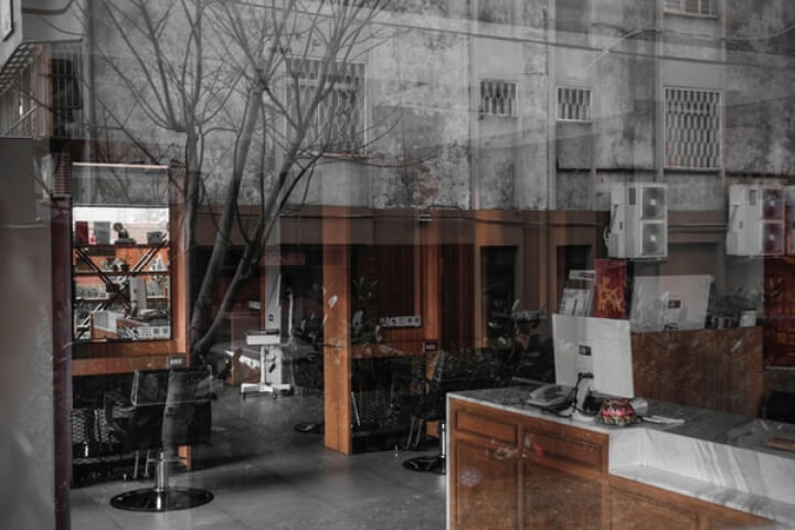 A monochrome image of a salon, showcasing a traditional barber shop with black and white aesthetics.