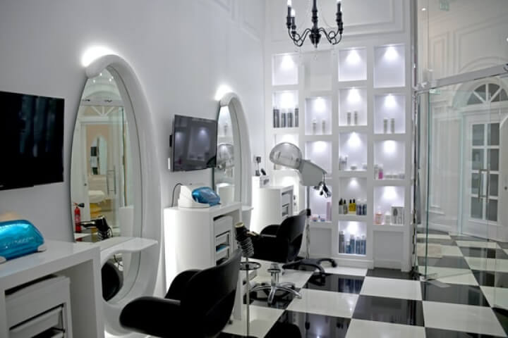 A stylish salon with a classic black and white checkered floor, exuding elegance and sophistication.