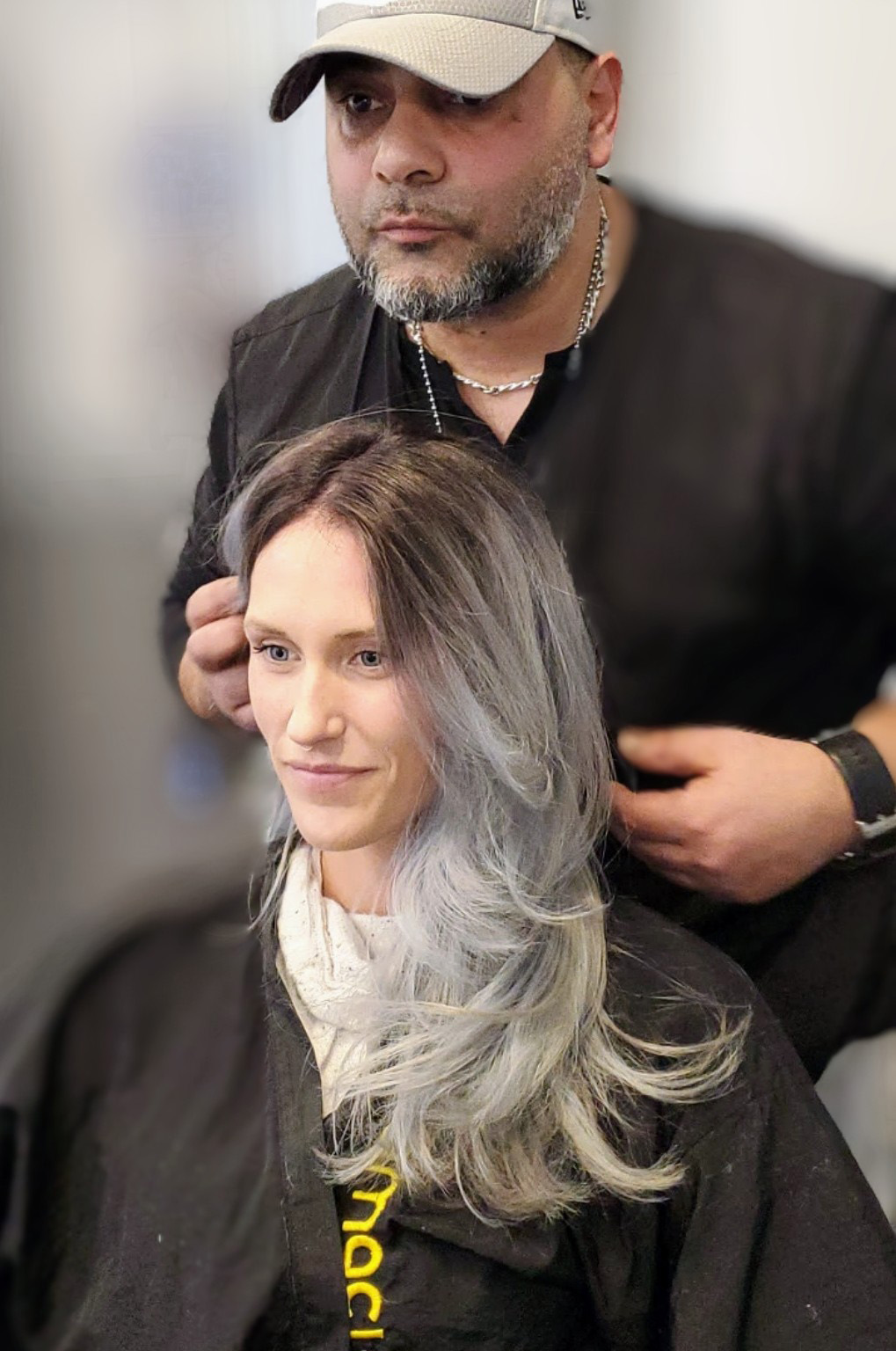 Smiley women with hairstylist