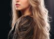 A stunning young woman with blonde balayage rubio flowing hair, radiating beauty and grace.