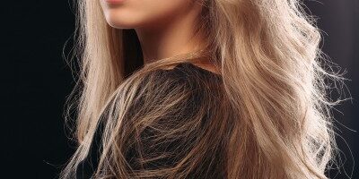 A stunning young woman with blonde balayage rubio flowing hair, radiating beauty and grace.